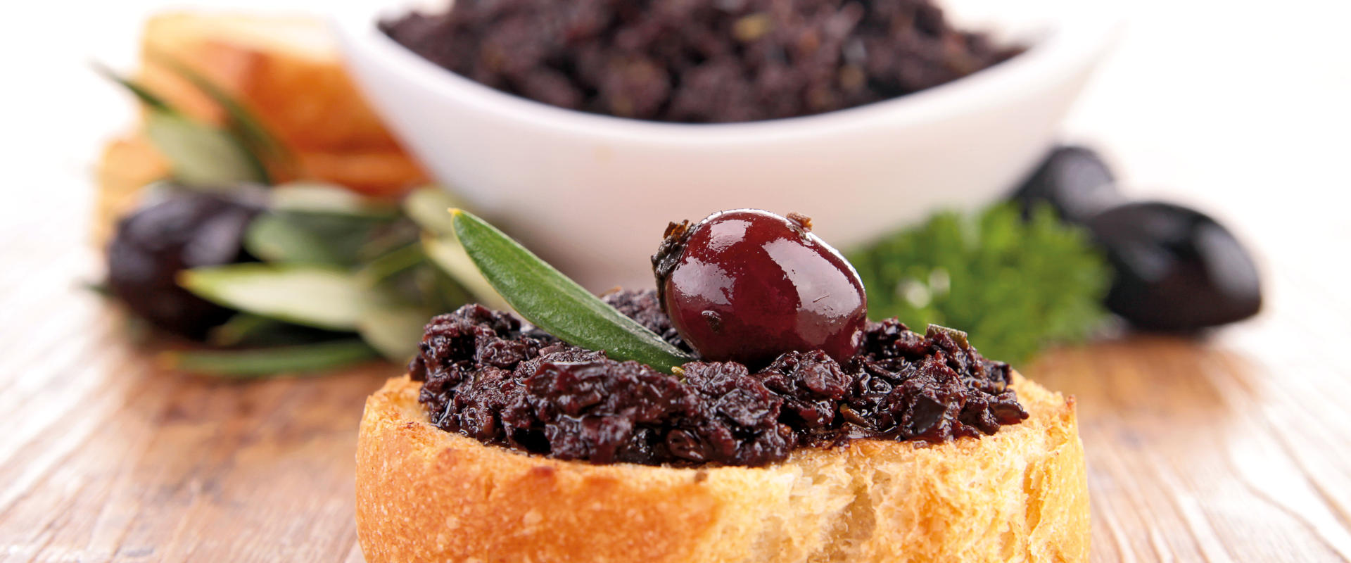 Bruschetta with olive spread on plate