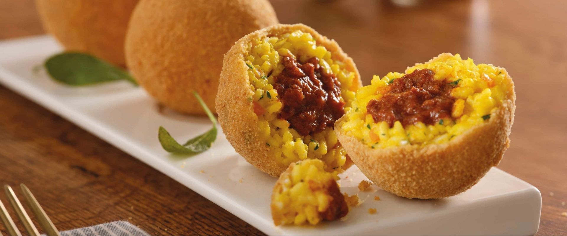 Saffron arancini filled with ragù, a classic of Italian cuisine