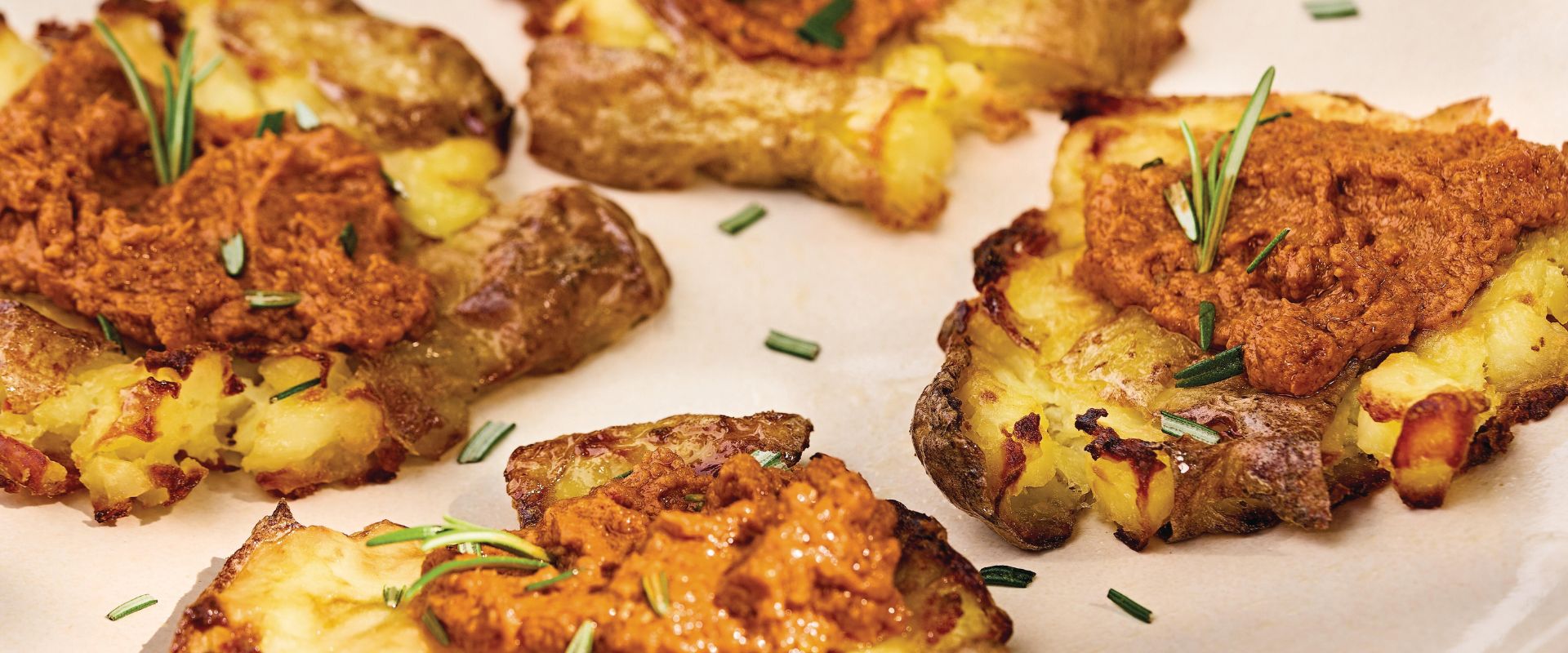 Crispy smashed oven potatoes with red pesto