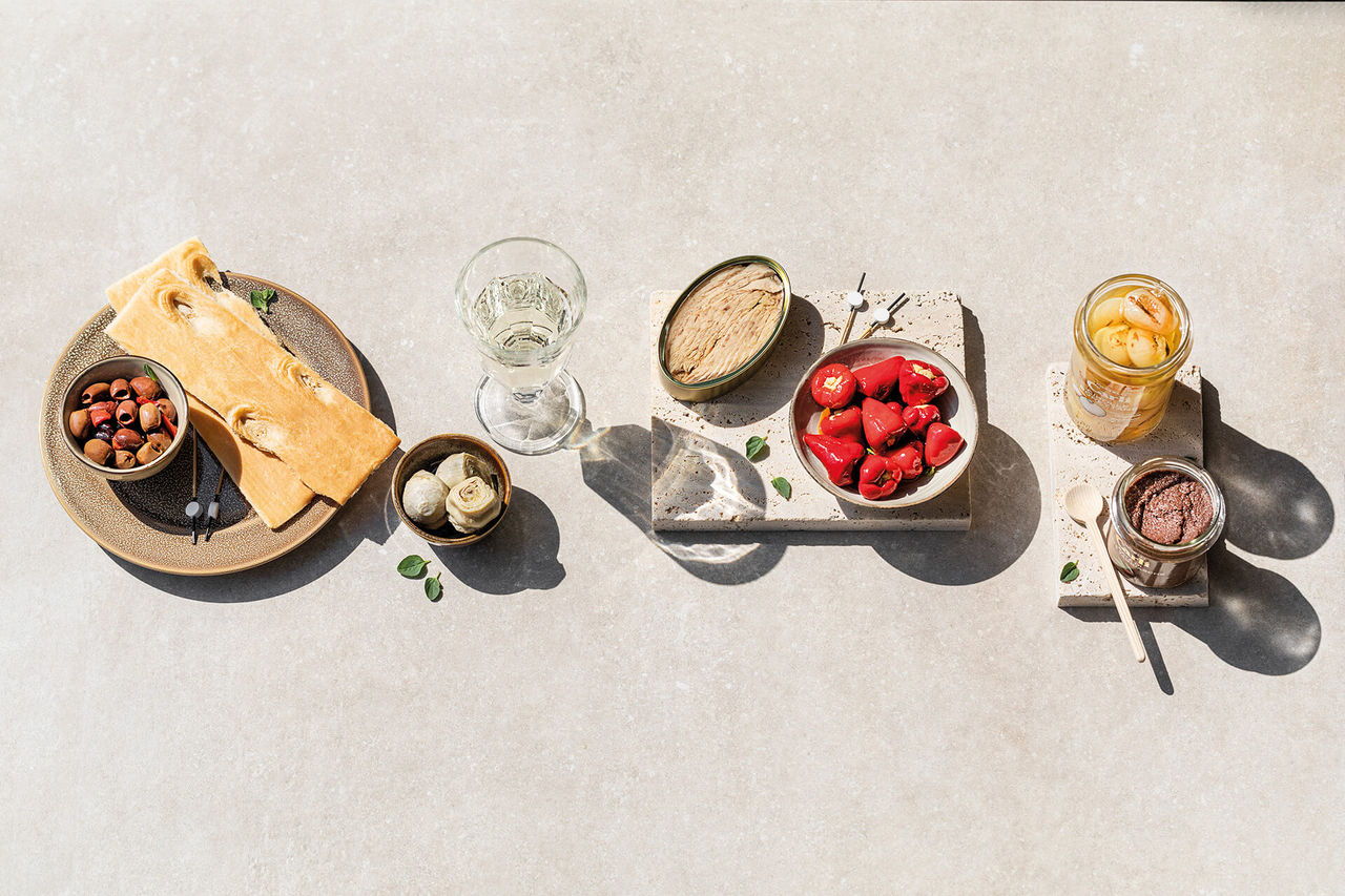 Aperitif header with Carli specialties on a withvivial table.